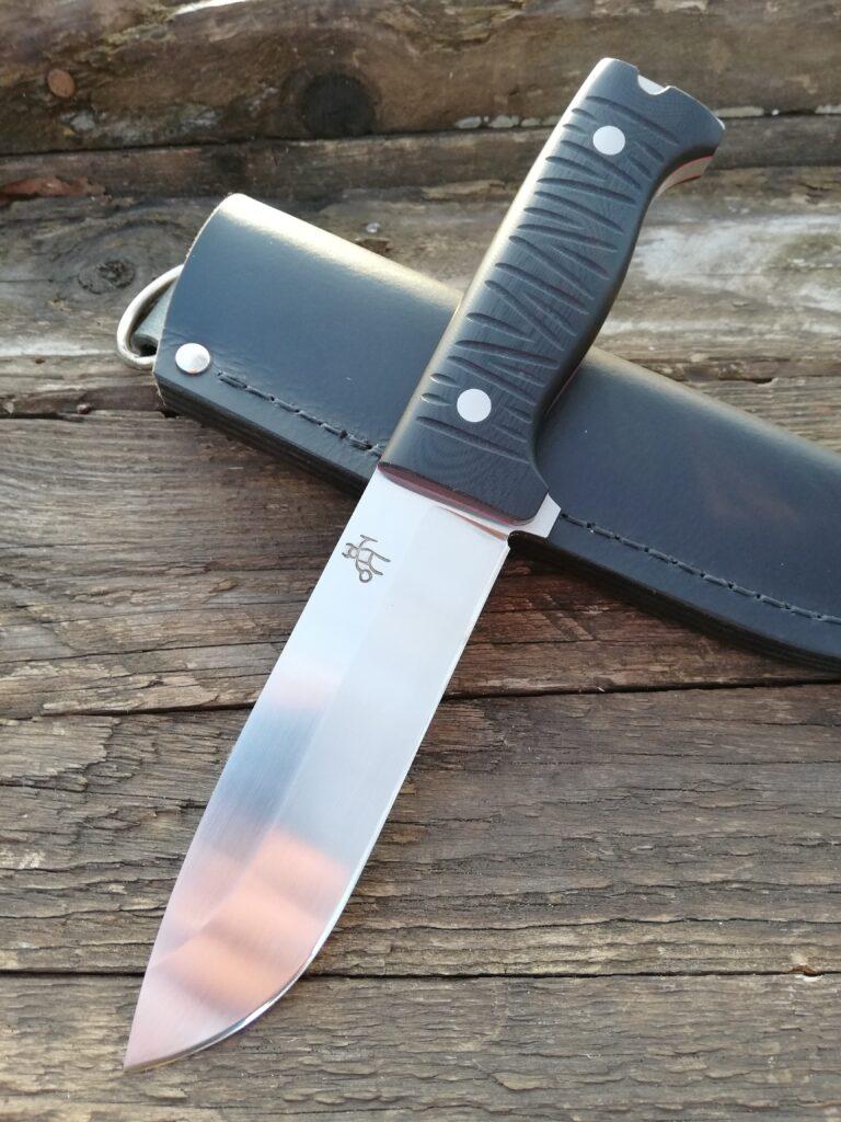 Scout knife with a grooved black handle on a leather sheath